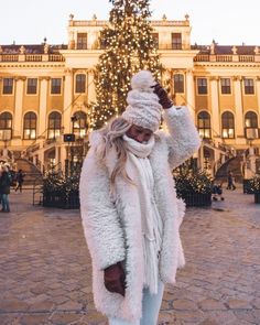 a woman standing in front of a christmas tree with the words what to pack for winter in europe