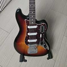 an electric guitar sitting on top of a wooden floor