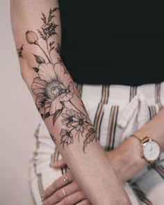 a woman with a flower tattoo on her arm