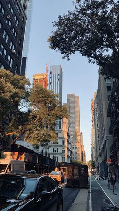 a city street with tall buildings in the background