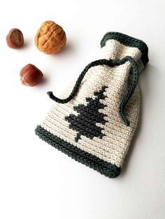 a crocheted bag with nuts on the side