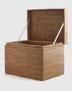 an empty wicker box with a white handle