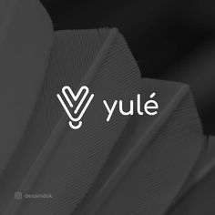 the logo for yule is shown in white and black colors on a dark background