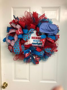 a red, white and blue mesh wreath on a door