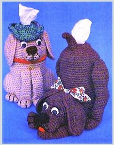 two crocheted dogs with hats on their heads and one dog wearing a dress