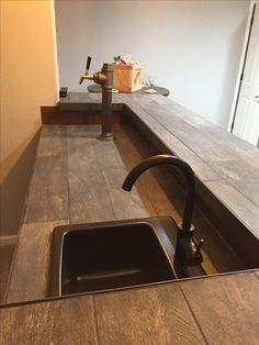 a kitchen counter with a sink and faucet