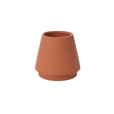 a brown vase sitting on top of a white wall