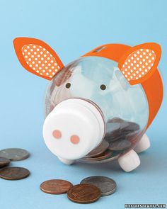 a piggy bank sitting on top of a pile of coins