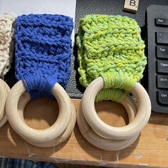 four wooden rings sitting on top of a table next to a keyboard and mouse pad