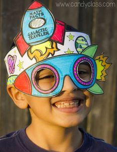 a young boy wearing a paper hat and sunglasses with stickers on it's face