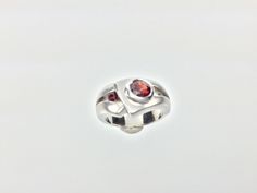 "Hi everyone, just wanted to let you know we are open and shipping daily. Silver Garnet Ring // Matte Platinum (Rhodium) Finish // Handmade // Modern Design // Size 7 Beautifully crafted \"one of a kind\" contemporary Sterling Silver ring with genuine Garnet center stone. This garnet is of a deep ruby red color. The silver ring is finished with Rhodium so it will not tarnish. This fine jewelry quality ring is perfect for work and formal occasions to match your sterling, white gold or platinum je Modernist Sterling Silver Wedding Rings, Modern Sterling Silver Rings For Anniversary, Modern White Gold Open Birthstone Ring, Modern Sterling Silver Rings With Round Cut, Oval Gemstone Rings In Modernist Style, Modernist Oval Sterling Silver Ring, Modern Jewelry With Accent Stones For Anniversary, Modernist Oval Gemstone Rings, Modern White Gold Birthstone Ring With Accent Stones