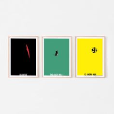 three minimalist posters are hanging on the wall