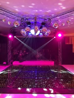 an empty dance floor with lights and disco balls