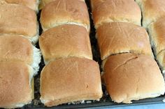 several rolls are lined up on a baking sheet and ready to be baked in the oven