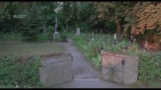 an entrance to a cemetery in the woods