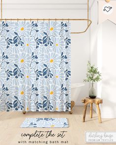 a bathroom with a blue and yellow shower curtain next to a white bath tub in front of a wooden stool