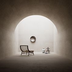 an empty room with two chairs and a clock on the wall in it's center