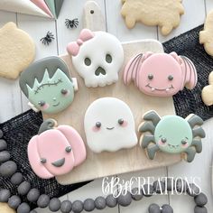 decorated cookies on a wooden board with black beads and decorations around them, including skulls