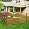 a wooden fence in front of a house with a dog sitting on top of it