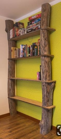 a book shelf made out of logs in the corner of a room with yellow walls