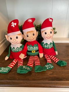 three elf dolls sitting on top of a shelf