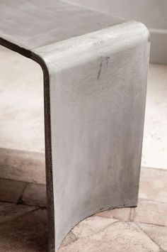 a metal table sitting on top of a tiled floor