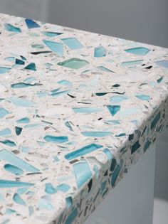 a blue and white counter top that has been made out of glass mosaics on it