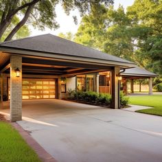 a garage is shown in the middle of a driveway with grass and trees around it