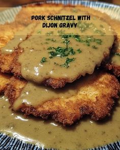 pork schnitzel with dijon gravy on a blue and white plate