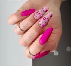 a woman's hand with pink and black nail polishes on her nails,