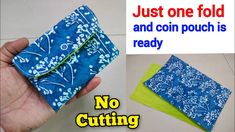 a hand holding a blue and white cloth with the words, just one fold and coin pouch is ready