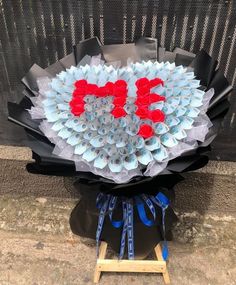 a bouquet made out of rolled up toilet paper with the word love spelled on it