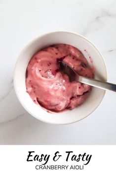 a bowl filled with ice cream on top of a white counter next to a spoon