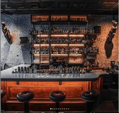 a bar with stools and shelves filled with bottles