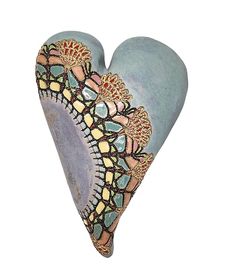 a ceramic heart shaped object on a white background