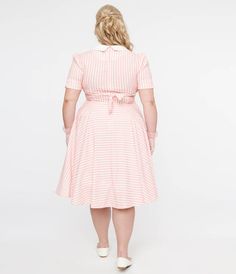 This classic 1950s style swing dress features pink & white stripes, perfect for adding some retro flair to your wardrobe. The dress also boasts a charming white collar and an attached waist tie for a flattering silhouette. With convenient side pockets and short sleeves, this dress is as practical as it is stylish.Available in sizes S-4X while supplies last. 1950s Style, Pink And White Stripes, Light Pink Color, Satin Material, 1950s Fashion, Unique Dresses, Inspired Dress, Retro Outfits, White Collar