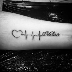 a heart and heartbeat tattoo on the arm