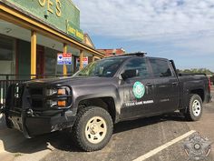 a black truck parked in front of a starbucks