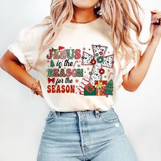 a woman wearing jeans and a t - shirt that says jesus is the reason for the season