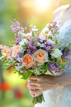 a bride holding a bouquet of flowers in her hands with the sun shining behind her