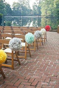 rows of wooden chairs with paper flowers on them