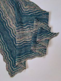 three pieces of blue and green knitted material