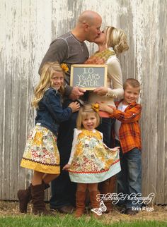 the family is posing for a photo with their chalkboard