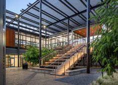 an open air building with stairs leading up to the top floor and second story area