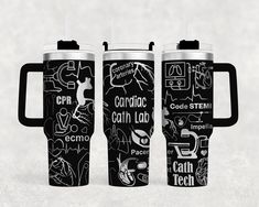 three black and white travel mugs with different types of writing on the sides, one is