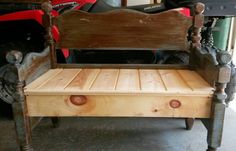 a wooden bench sitting in a garage next to a motor scooter behind it