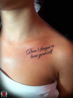 a woman with a tattoo saying don't forget to love yourself on her chest