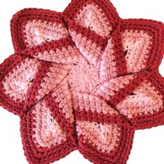 crocheted red and pink coasters sitting on top of each other