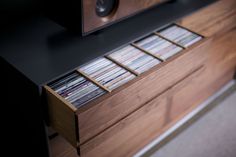 an entertainment center with several cd's on it