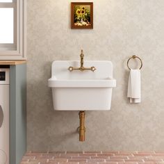 a white sink sitting under a window next to a dryer